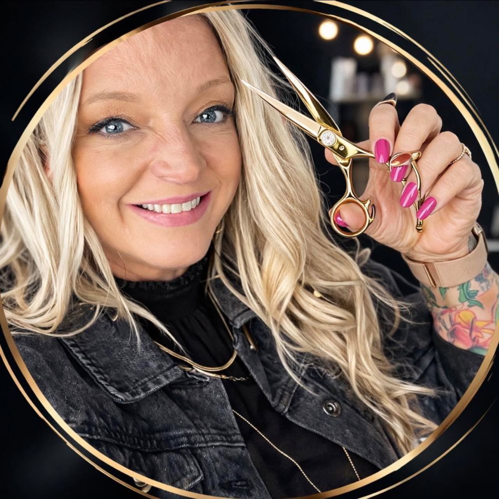 Karli Spencer, owner of Salon Karli, holding her shears